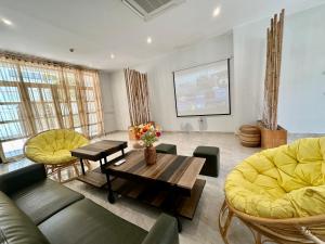 a living room with a couch and chairs and a table at 8BR West coast Phu Quoc townhouse by beach and shared swimming pools in Phú Quốc