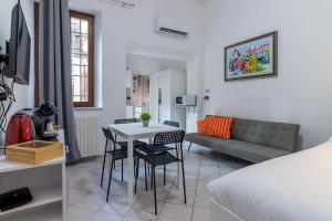 a room with a bed and a table and chairs at [Debe-A due passi da StazioneFs] in Ferrara