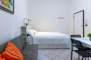 a living room with a bed and a couch at [Debe-A due passi da StazioneFs] in Ferrara