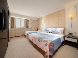 a hotel room with two beds and a television at Dorsett Chengdu in Chengdu +86 photos