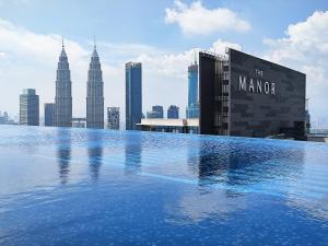 a swimming pool on top of a building with a city at EATON Residences by WSD in Kuala Lumpur