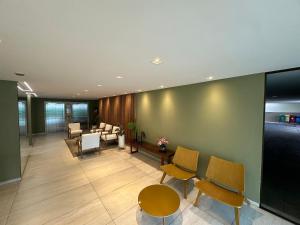 an office lobby with chairs and a waiting room at Atlantis Cabo Branco by Allmare Apartamentos in João Pessoa