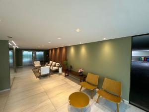 an office lobby with chairs and a waiting room at Atlantis Cabo Branco by Allmare Temporada in João Pessoa
