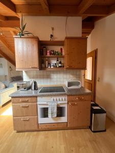 a kitchen with a stove top oven in a room at Gemütliche Dachgeschosswohnung mit Balkon in Ainring