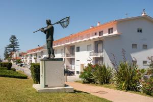 a statue of a woman holding a tennis racket at GuestReady - Pleasant Retreat in Moledo in Moledo