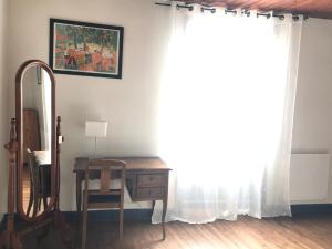 a room with a desk and a mirror at villa Marguerite terrasse & garage in Belvès