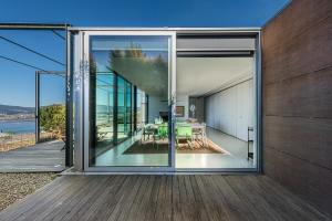a glass house with a view of the ocean at GuestReady - Lugar do Monte Seixas in Caminha