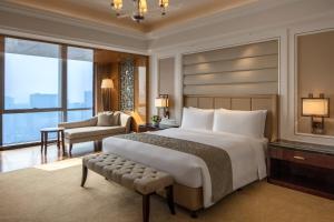 a bedroom with a large bed and a living room at The Ritz-Carlton, Chengdu in Chengdu +37 photos