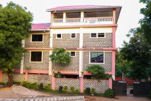a building with a lot of windows on it at Pebbles guesthouse in Diani beach road in Ukunda
