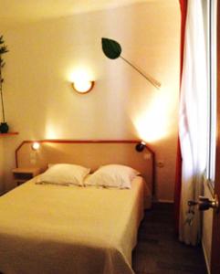 Una cama o camas en una habitación de Hôtel La Croix de Malte