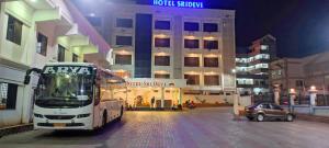 a bus parked in front of a hotel at night at Hotel Sri Devi in Kanyakumari