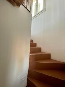 a staircase in a room with a window at Altana della Ruggera in Modena