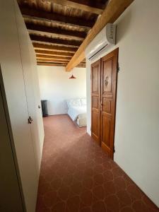 a room with a bedroom with a bed and a door at Altana della Ruggera in Modena