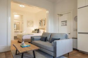 a living room with a couch and a bed at Modern 1-Bed Studio near Tramsheds in Sydney