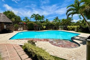 uma piscina num quintal com palmeiras em Duplex design sea view em Papeete