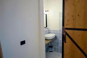 a bathroom with a white sink and a toilet at A Casa Da Angelo - Country House PrivatePool & AirCO in Grottammare