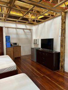 a room with two beds and a flat screen tv at Pearl Resort Panglao,Dauis Bikini Beach in Dauis