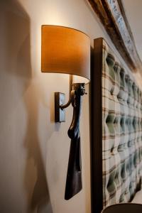 una lámpara en una pared con una lámpara en ella en The White Hart Hotel en Hingham