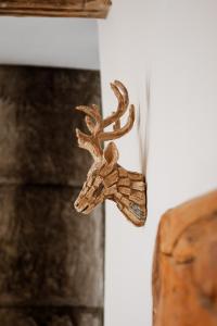 a wooden deer head hanging on a wall at The White Hart Hotel in Hingham