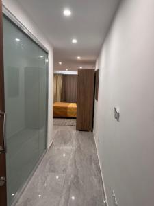 a room with a glass door leading to a bedroom at La Bella Guesthouse in St. Julianʼs