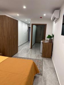 a hotel room with a bed and a hallway at La Bella Guesthouse in St. Julianʼs