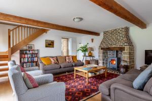 a living room with two couches and a fireplace at The Coach House, Wrexham Road in Wrexham