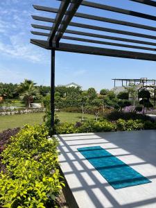 a view of a pool with a patio at Luxurious Farmhouse with Pool outside Delhi in Noida