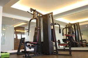 a gym with a row of tread machines at Sree Dhanya Vantage point in Trivandrum