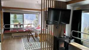 uma sala de estar com uma televisão de ecrã plano na parede em Bellavista Marilleva 1400 - Val di Sole em Marilleva