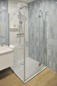 a shower with a glass door in a bathroom at Apartament D013 Polanki Aqua in Kołobrzeg