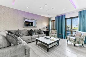 a living room with a couch and a table at 3 bedroom Villa Eleyjo with stunning private pool, Aphrodite Hills Resort in Kouklia