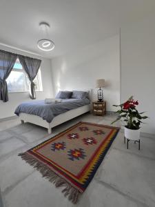 a bedroom with a bed and a rug at Luxury 2 Bed Apartment in Royal Sutton Coldfield in Sutton Coldfield