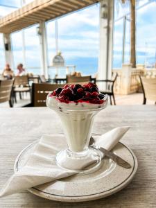 a dessert with cherries in a glass bowl on a table at Perla Marina in Nerja