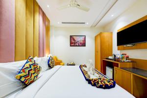 a hotel room with a large bed and a flat screen tv at Classio Royale By IO Hotels in Amritsar