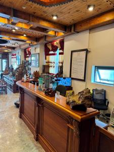 a restaurant with a large wooden counter in a room at Hoàng Khiêm Hotel in Pleiku