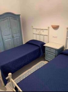 a bedroom with two beds and a nightstand and a bed sidx sidx sidx sidx at Villa Cristallina Piscina privata, Wi-Fi & Netflix in Stintino +12 photos