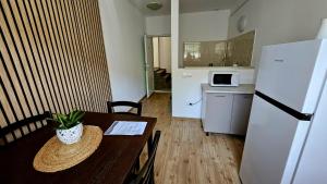 a small kitchen with a table and a refrigerator at Apartamente elegante in regim hotelier in Iaşi +34 photos