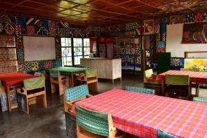 NyakinamaにあるRoom in BB - Red Rocks Rwanda - Triple Roomのレストラン内のダイニングルーム(テーブル、椅子付)