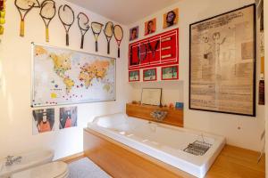 a bathroom with a tub and a map and a sink at Palladio 20 Loft and Terrace in Verona