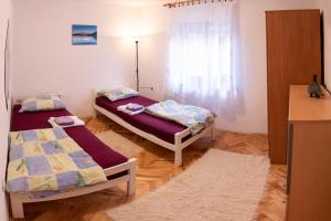מיטה או מיטות בחדר ב-Apartman Lički san