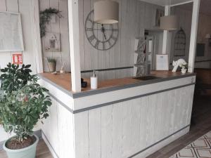 a kitchen with a counter top with a plant at Hôtel Les Thermes in Jonzac