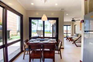 a kitchen and dining room with a table and chairs at Hey Jude Bulabog Beachfront Residence in Boracay