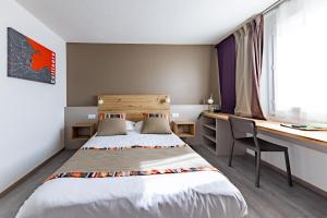 um pequeno quarto com uma cama e uma secretária em Hôtel Princes de Catalogne em Collioure