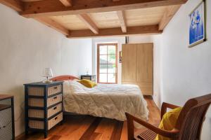 a bedroom with a bed and a dresser and a window at Maison pour 2 adultes - 4 enfants - 600m plage in Le Fier