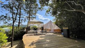 a tent with a table on a wooden deck at Shimanto Yamamizuki - Vacation STAY 36960v in Shimanto