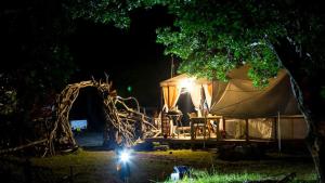 a tent at night with a table and lights at Shimanto Yamamizuki - Vacation STAY 36951v in Shimanto