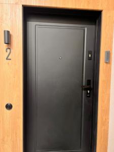 a black door with the number two on it at Apartament Old Town Bednarska 22 in Elblag