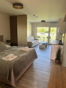 a bedroom with a bed and a living room at Motel M in Malacky