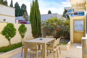 a patio with a table and chairs in a yard at Stunning 4BR Villa with private terrace in Balzan by 360 Estates in Balzan