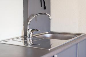 a stainless steel sink in a kitchen at GuestReady - Riverside retreat in Porto in Porto